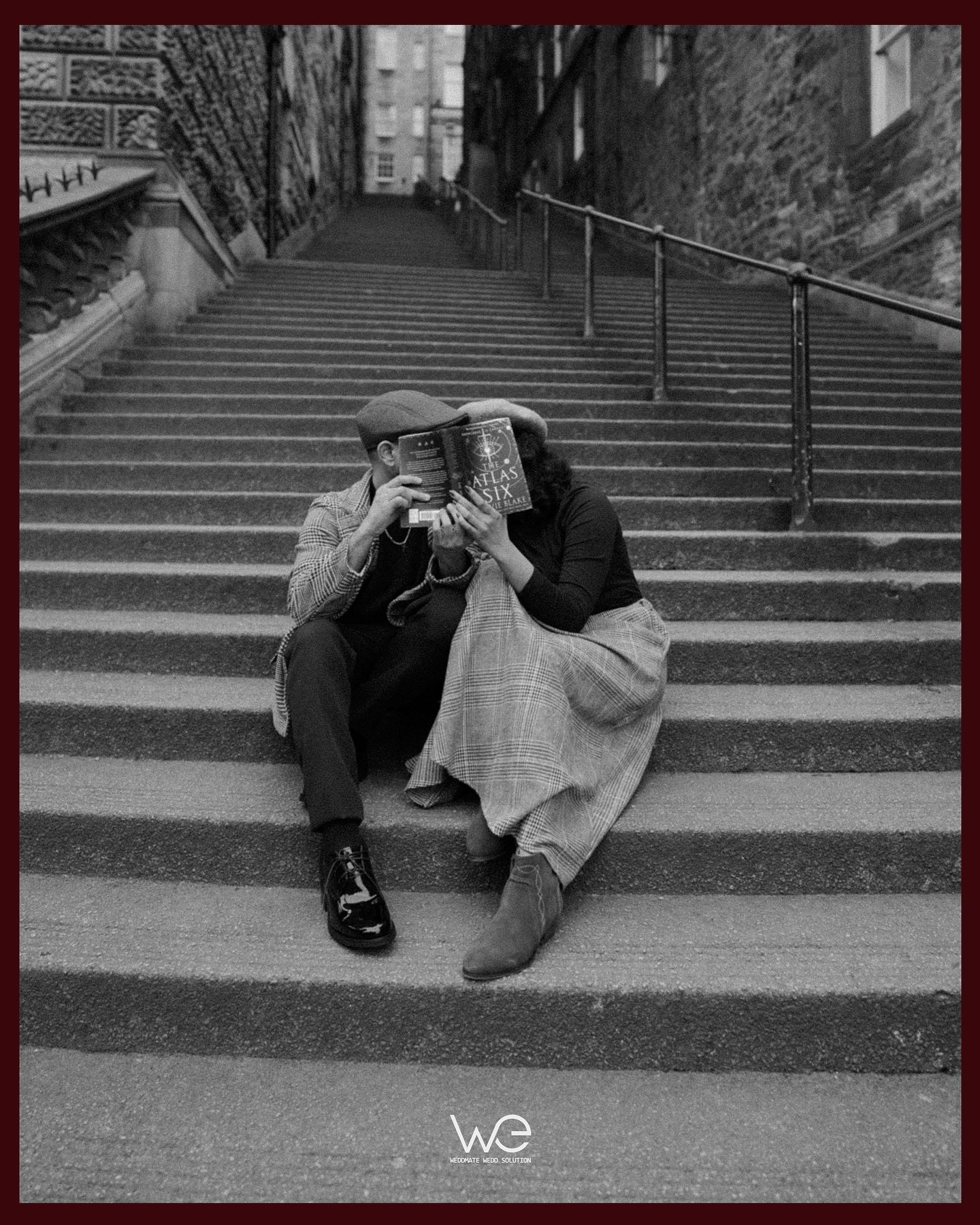 A couple embracing on a grand stone staircase