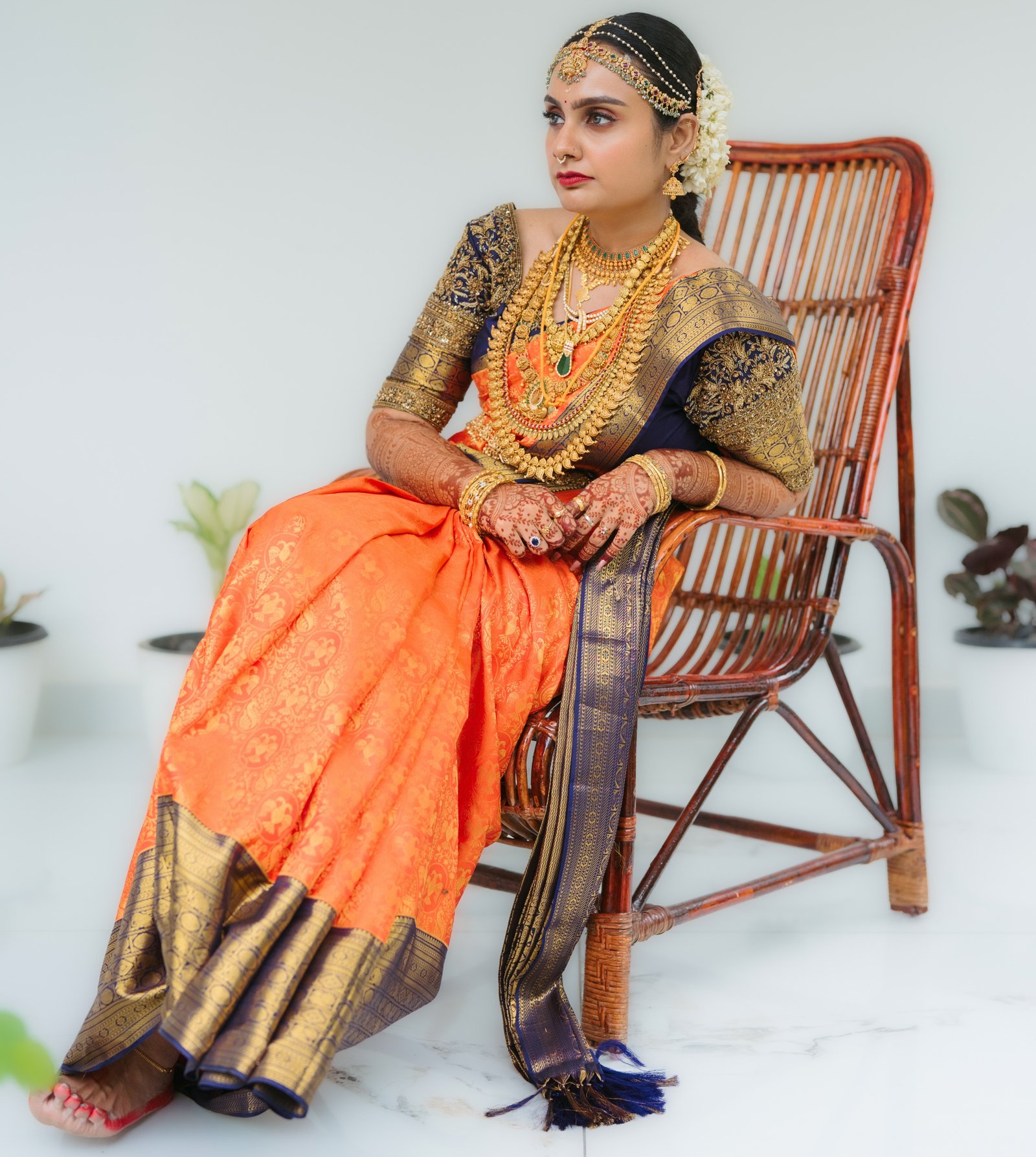 A bride seated in vibrant traditional wedding attire